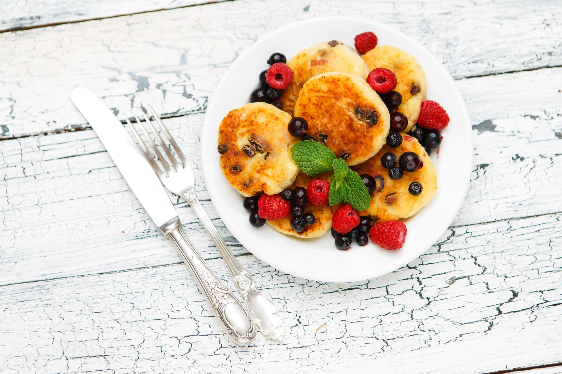 Fluffy Russian Syrniki with Berries and Honey