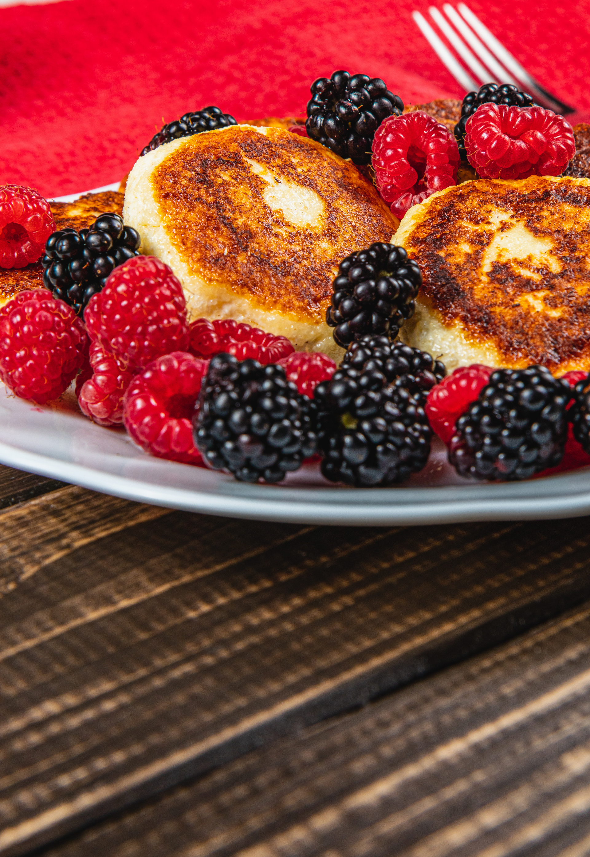 Fluffy Russian Syrniki with Berries and Honey